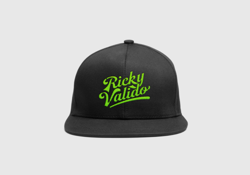 a black cap with green Ricky Valido text